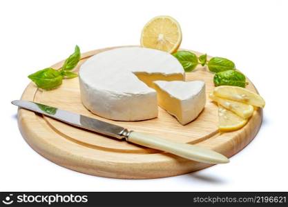 Round brie or camambert cheese on cutting board isolated white background. Round brie or camambert cheese on cutting board white background
