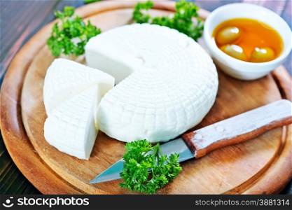 round cheese and aroma spice on wooden board