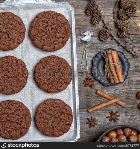 round chocolate cookies on an iron plate, top view