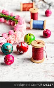 Round colored beads,spools of threads for needlework