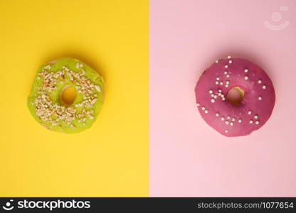 round different donuts with sprinkles on a bright multi-colored background, top view