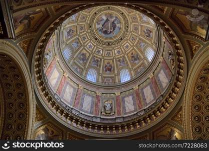 Round Dome of Catholic Cathedral inside with beautiful decoration, colorful painting mural and frescoes in Budapest Hungary.Budapest.. Wonderful paintings, murals and frescoes on the Dome of Catholic Cathedral in Budapest.
