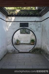 Round doorway into small courtyard in Yu or Yuyuan Garden in  the old city of Shanghai. Doorway to small courtyard in Yuyuan or Yu Garden in Shanghai
