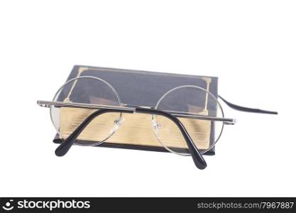 Round Eyeglasses and book isolated on white