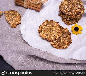 round homemade oatmeal cookies on a white sheet of paper