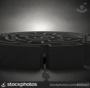 Round labyrinth. Rear view of businesswoman standing near labyrinth entrance