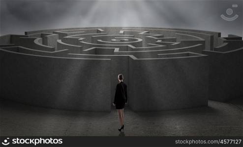 Round labyrinth. Rear view of businesswoman standing near labyrinth entrance