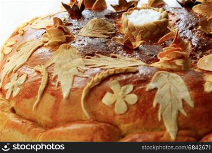 round loaf with floral pattern with salt. beautiful round loaf with floral pattern of flowers and leaves with salt