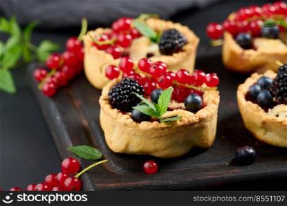 Round mini fruit pie on a wooden board