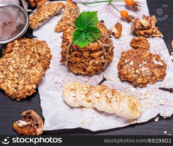 round oatmeal cookies on white sheet of paper, top view