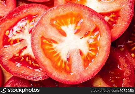Round pieces of fresh tomato. Macro background. Tomato texture. High quality photo. Round pieces of fresh tomato.
