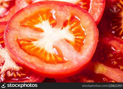 Round pieces of fresh tomato. Macro background. Tomato texture. High quality photo. Round pieces of fresh tomato.