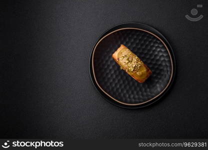 Round puff pastry croissant with raspberry filling or new york roll on dark concrete background