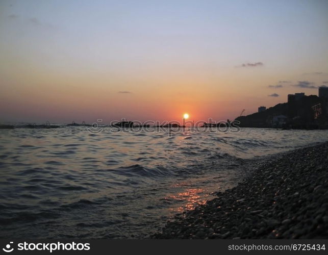 Round sun falling down over the Black sea