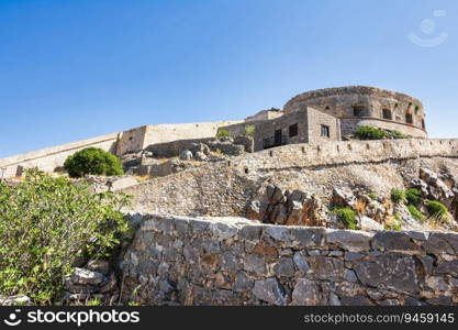 Round tower of Spinalonga fortress. Crete, Greece. Until 1957 used as a leper station, now it is a popular tourist destination.. Round tower of Spinalonga fortress. Crete, Greece
