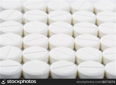 Round white pills. Round white medical tablets on bright background