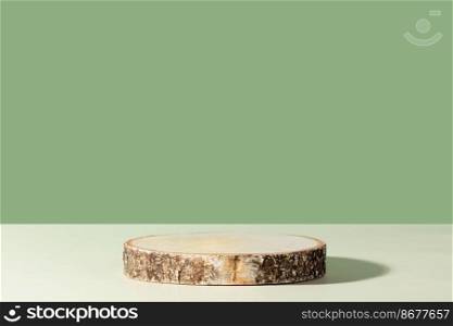 Round wooden saw cut cylinder shape on green background abstract background. Minimal box and geometric podium. Scene with geometrical forms. Empty showcase for eco cosmetic product presentation