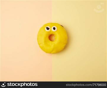 round yellow banana donut on a colored background, flat lay