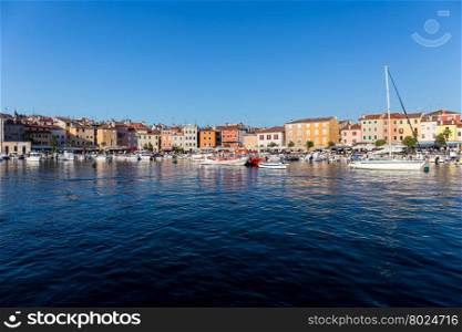 ROVINJ, CROATIA - JULY 2 : A large group of boats anchored in the marina with a view of the city promenade and the old city core on July 2, 2015 in Rovinj, Croatia.