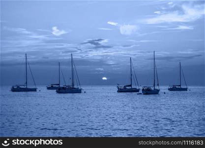 Rovinj, Croatia - May 21, 2018: Evening view on Yachts, fishing boats and the Adriatic sunset sea, Rovinj, Croatia. Trendy banner toned in classic blue - color of the 2020 year. Evening view on Yachts, fishing boats and the Adriatic sunset sea, Rovinj, Croatia.