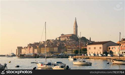 Rovinj marina and city view with boats and St. Euphemia cathedral at sunset. Istria, Croatia.. Rovinj marina and city view at sunset