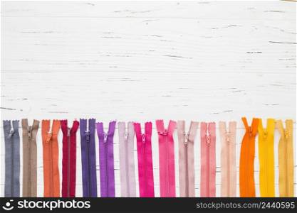 row multi colored zippers wooden background