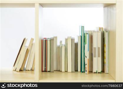 Row of books in a wooden bookcase