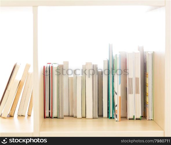 Row of books in a wooden bookcase