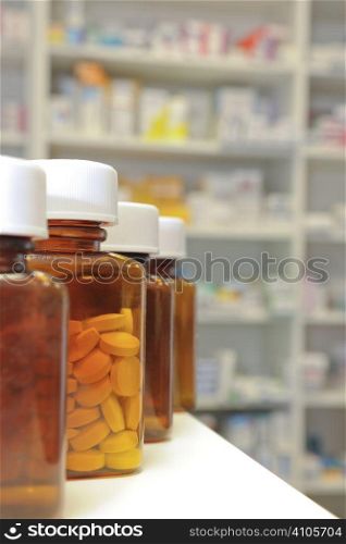 row of bottles and pills on a chemists counter
