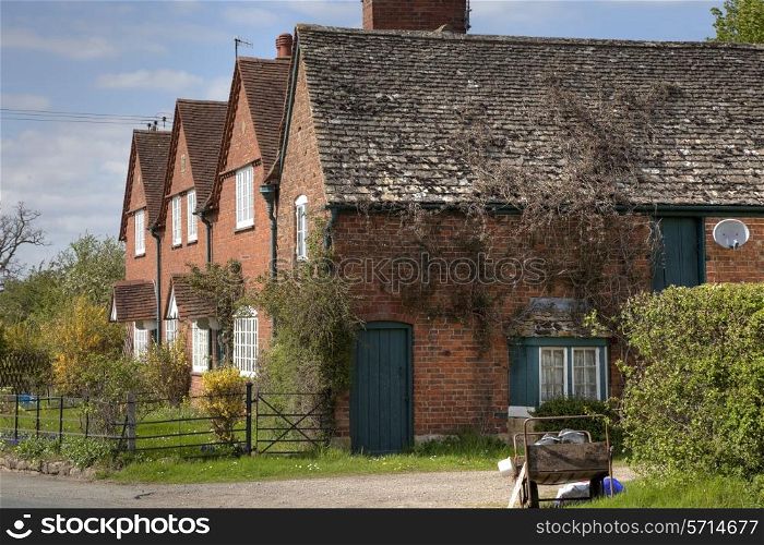 Row of brick cottages, Gloucestershire, England.