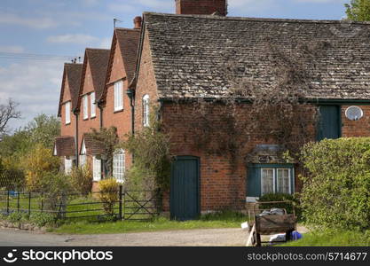 Row of brick cottages, Gloucestershire, England.