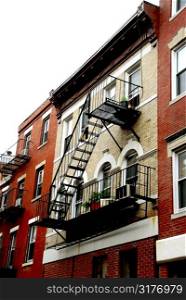 Row of brick houses in Boston historical North End metal fire escapes