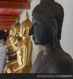 Row of Buddha statues in Wat Pho, Phra Nakhon, Bangkok, Thailand