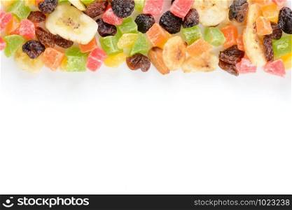 Row of colorful dry fruits isolated on white background. To be used as frame or border