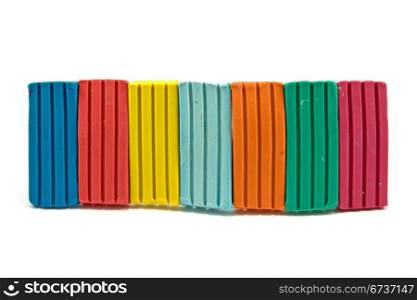 row of colorful plasticine on white background