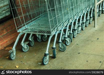 Row of empty shopping cart trolley. Market grocery shop and retail concept. Outdoor.