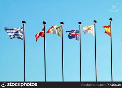 Row of european flags against blue sky background