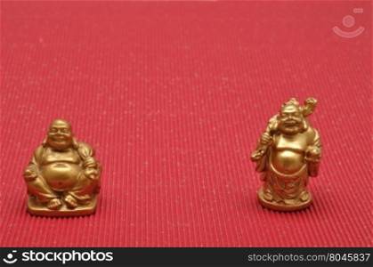 Row of Figurines of laughing and cheerful golden Buddhas