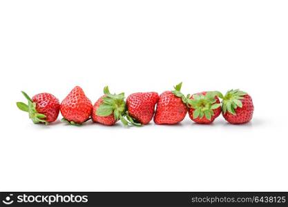 row of fresh strawberries isolated on white