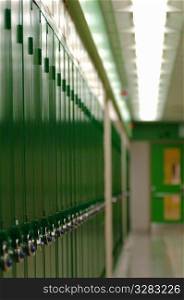 Row of green school lockers in hallway.