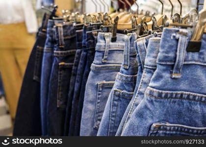 Row of hanged blue jeans skirts in shop