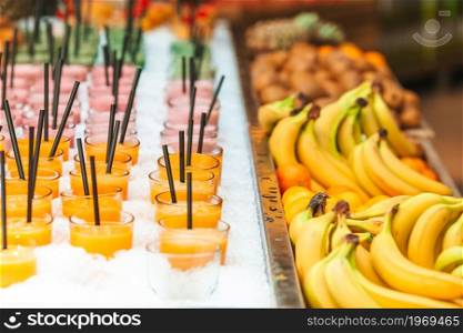Row of healthy fresh fruit and vegetable smoothies with assorted ingredients. Assorted fruit shakes closeup. Smoothie concept. Row of healthy fresh fruit and vegetable smoothies with assorted ingredients.