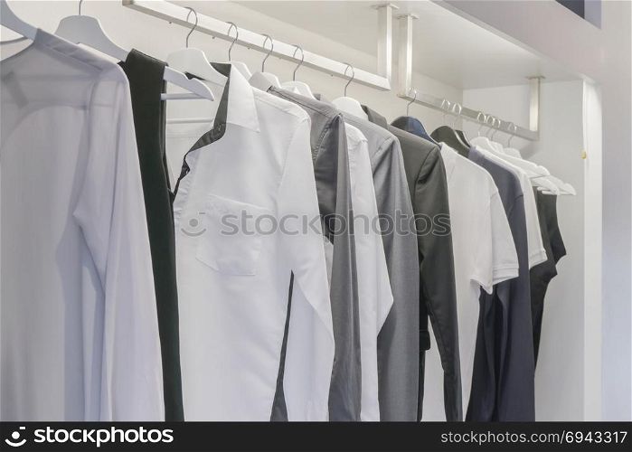 Row of men&rsquo;s shirt hanging in wardrobe