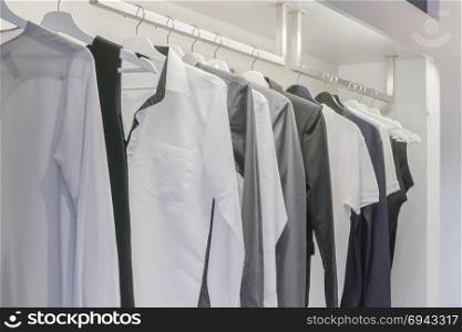 Row of men&rsquo;s shirt hanging in wardrobe