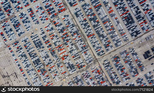 Row of new cars for sale in port at cars export terminal.