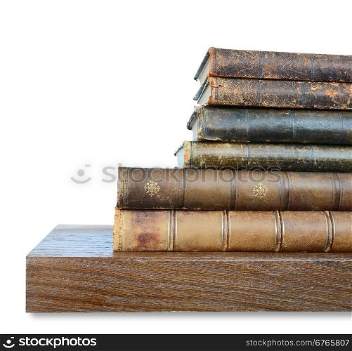 Row of old books on a wooden shelf
