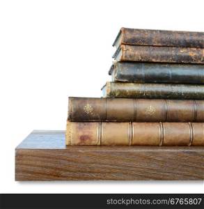 Row of old books on a wooden shelf