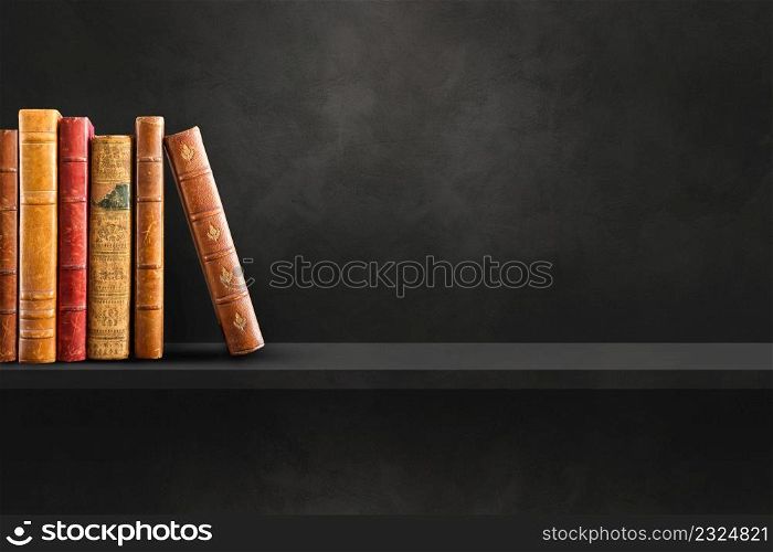 Row of old books on black shelf. Horizontal background scene. Row of old books on black shelf. Horizontal background