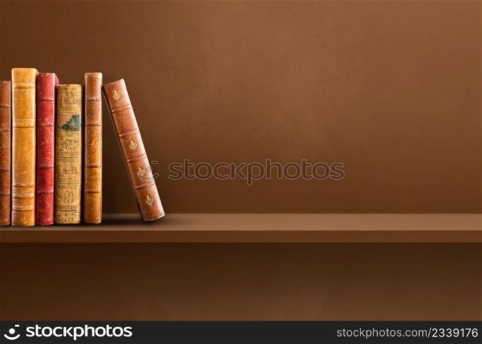 Row of old books on Brown shelf. Horizontal background scene. Row of old books on brown shelf. Horizontal background