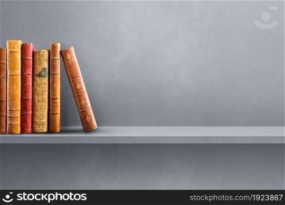 Row of old books on grey shelf. Horizontal background scene. Row of old books on grey shelf. Horizontal background